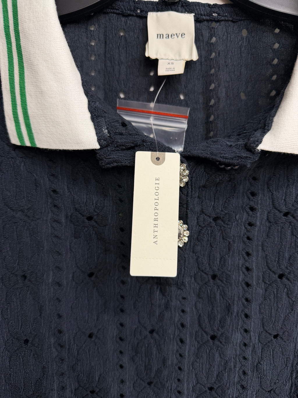 Navy textured knit polo top by Anthropologie Maeve with puff sleeves and jewel buttons, size XS, worn styled casually.