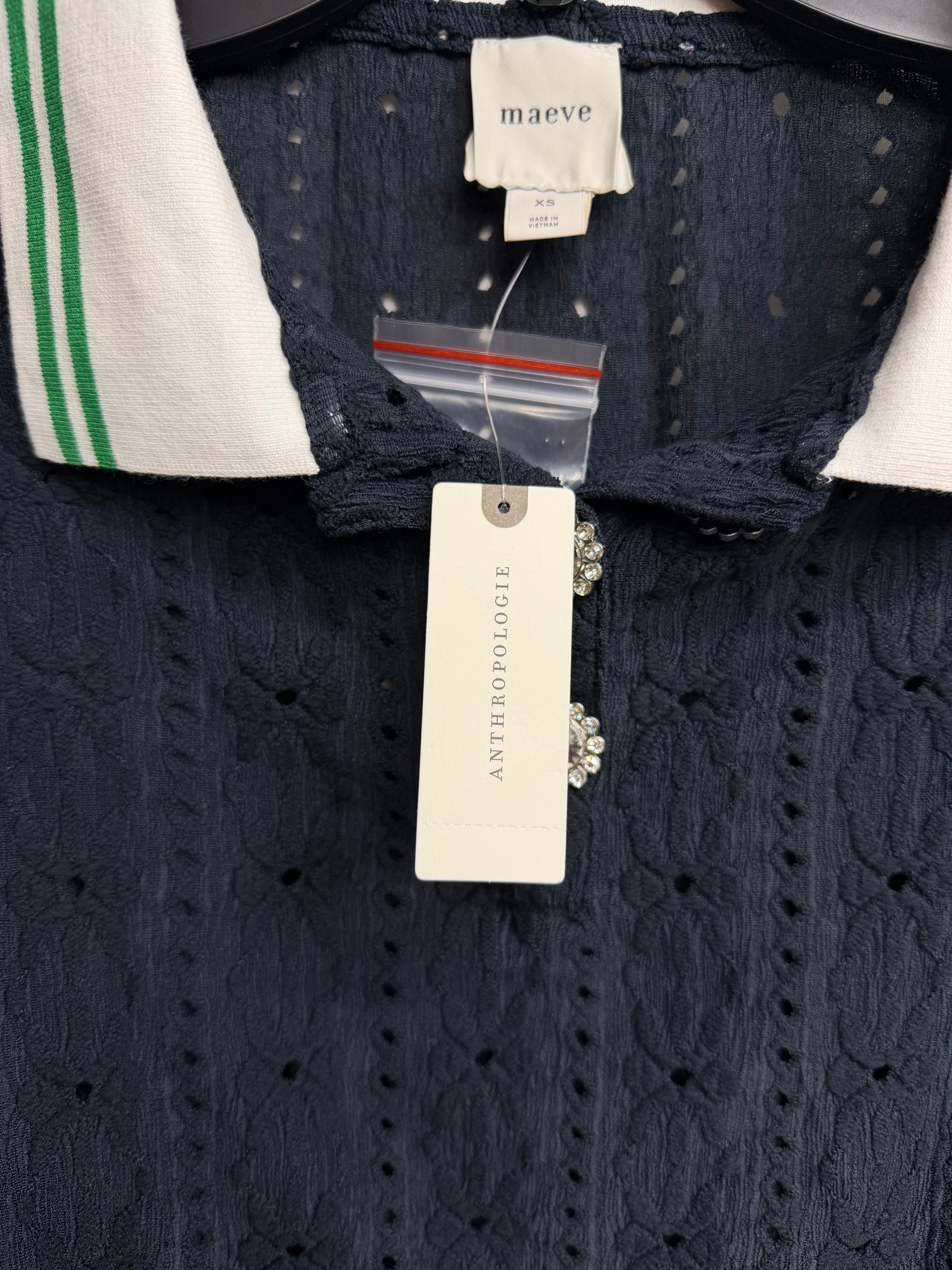 Navy textured knit polo top by Anthropologie Maeve with puff sleeves and jewel buttons, size XS, worn styled casually.