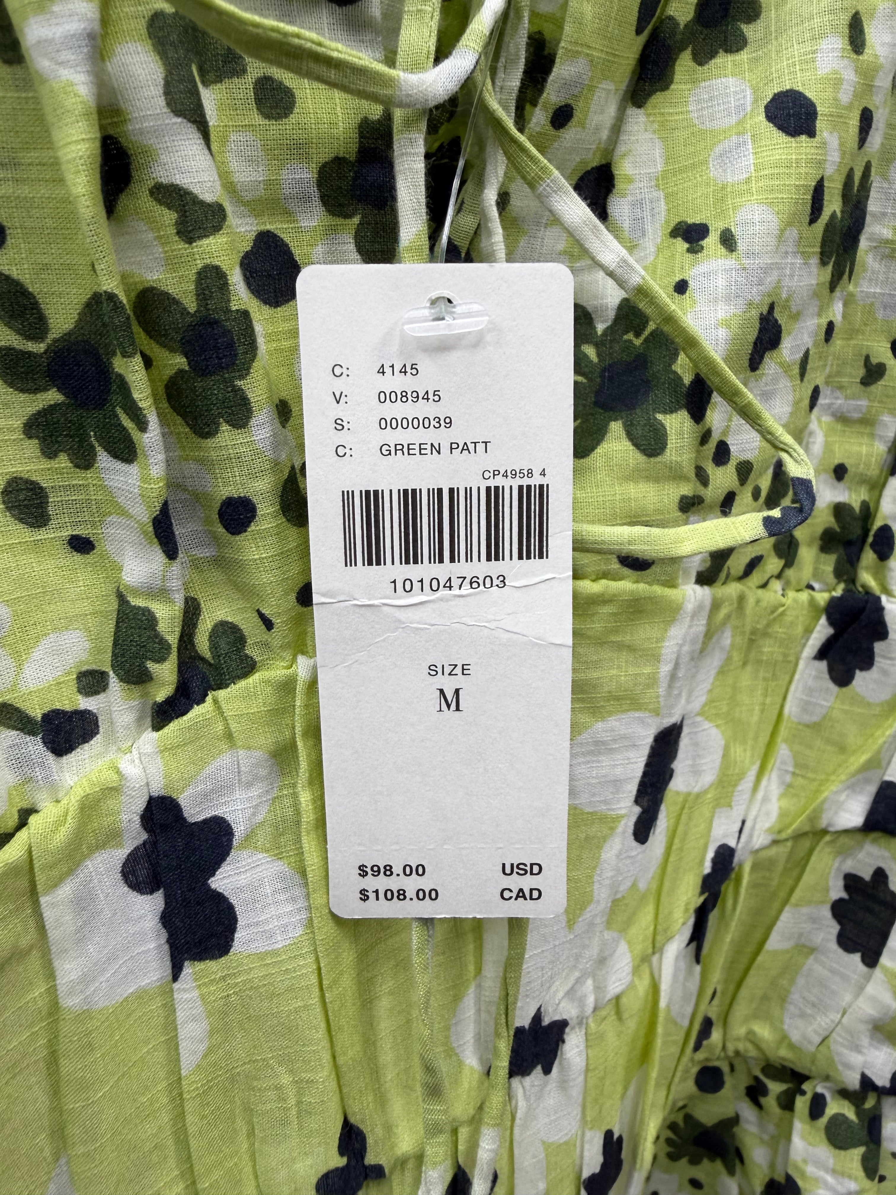 Green floral tiered mini dress by Diverse Finds, featuring a flowing silhouette and vibrant floral pattern, size medium.